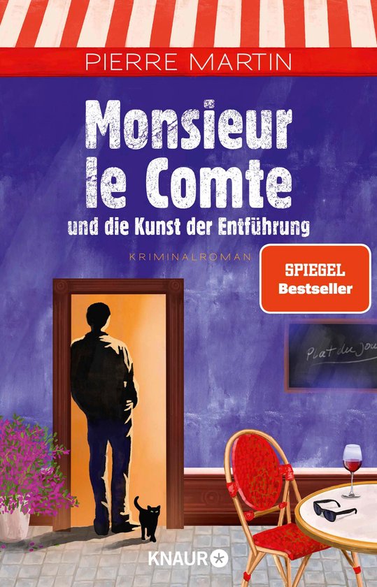 Couverture du livre Monsieur le Comte und die Kunst der Entführung par Pierre Martin. Un homme se tient dans une porte avec un chat noir. Une table avec des chaises est à l'extérieur.