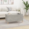 Betongrijze salontafel in een woonkamer, met gesloten blad.