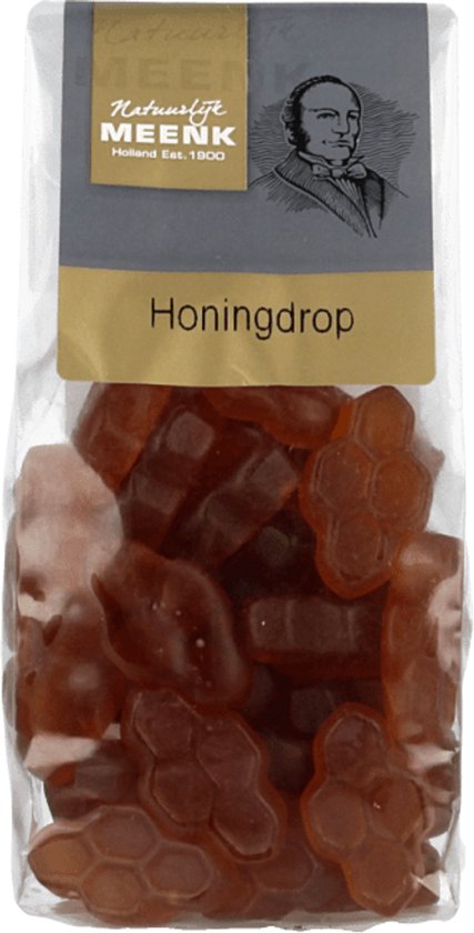 Zakje met oranje honingdropjes in honingraatvorm.