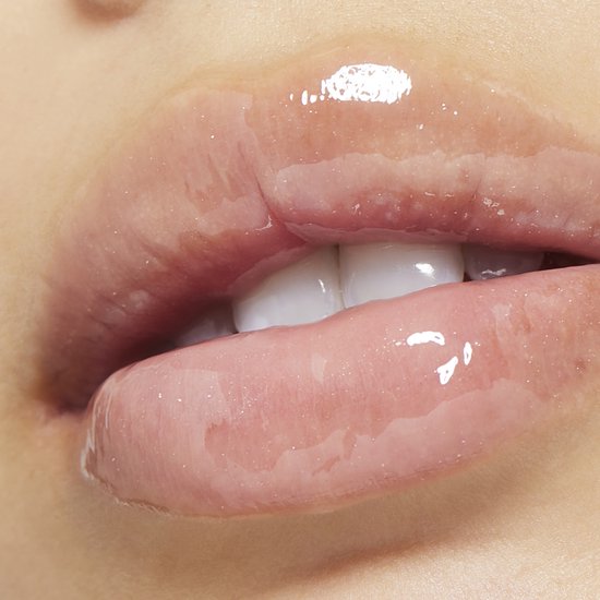 Close-up van lippen met transparante, glanzende lipgloss. Een lichte roze tint en vochtige afwerking.