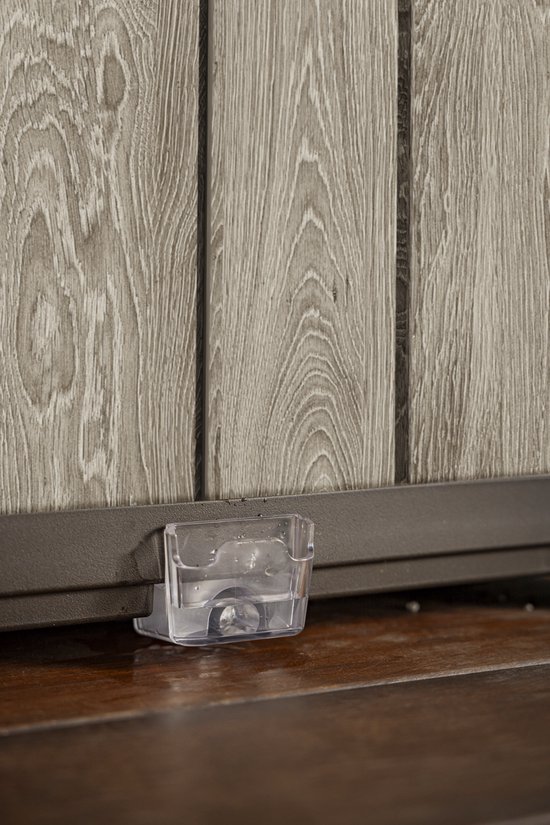 Transparant wateropvangbakje met scharnierend deksel, onder een grijze plantenbak.