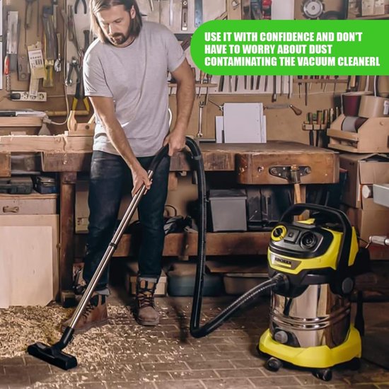 Een man met een baard die een werkplaats opruimt met een gele en zilveren stofzuiger.