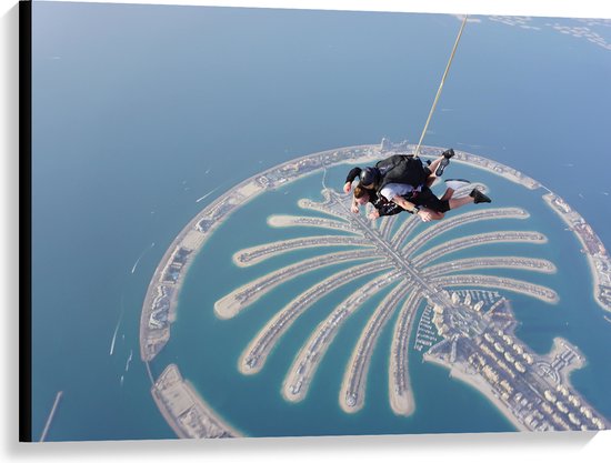 Canvas - Parachutespringer boven de Palm van Dubai - 100x75 cm Foto op Canvas Schilderij (Wanddecoratie op Canvas)
