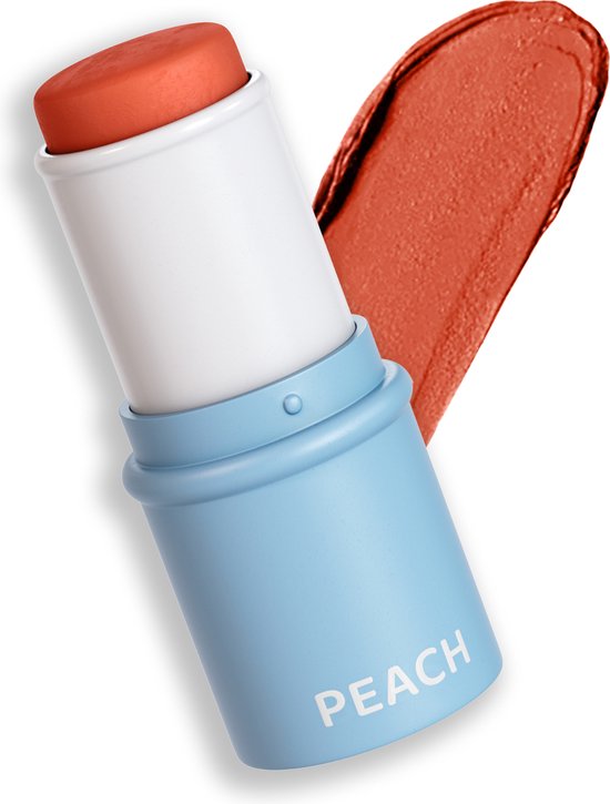 Perzikkleurige blush stick met blauwe dop, met de tekst 'PEACH', met een uitgesmeerde oranje-perzik kleurige swatch.