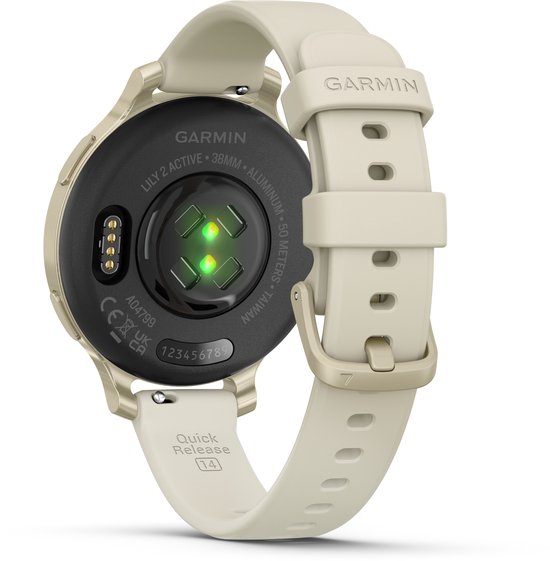 Achterkant van een gouden smartwatch met wit bandje. Toont hartslagmeter en tekst "GARMIN LILY 2 ACTIVE 38MM ALUMINUM..."