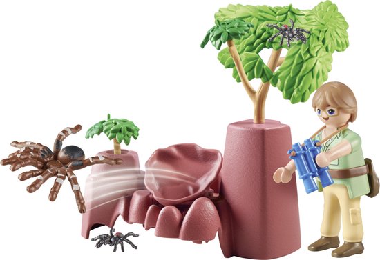 Playmobil figuur met blauwe verrekijker, spinnen en roze rotsen met planten.