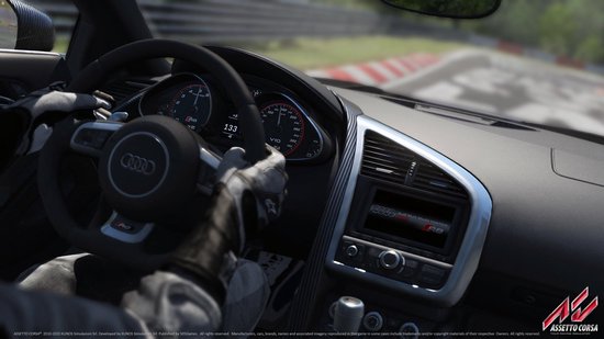 Bestuurdersperspectief van een Audi R8 dashboard met de handen aan het stuur.