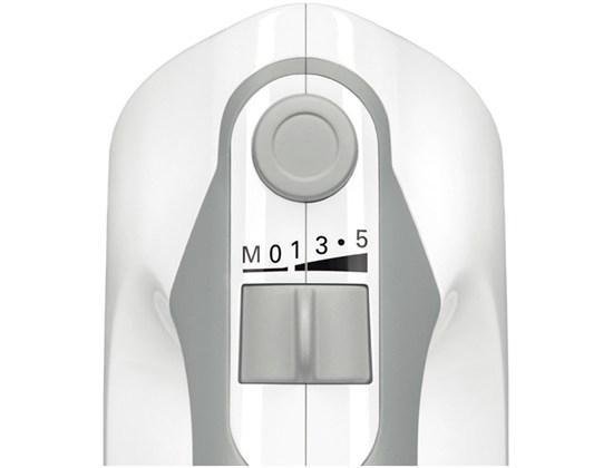Gros plan van de snelheidsregelaar (M, 0, 1, 3, 5) en een knop op een witte Bosch handmixer.