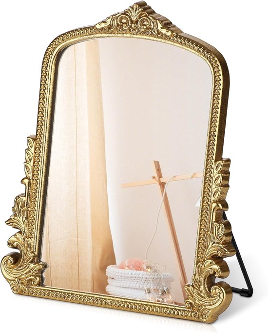 Miroir doré orné sur fond blanc.
