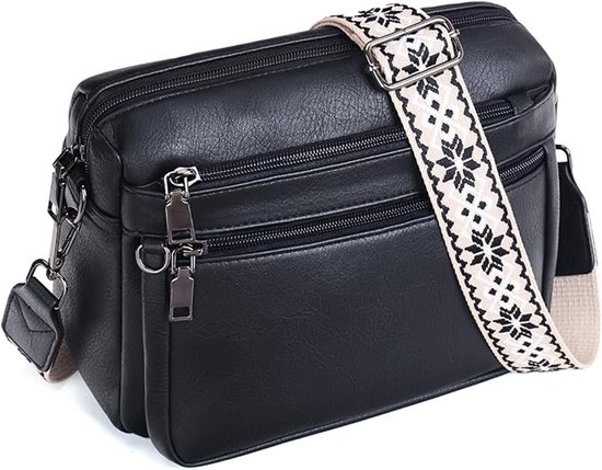 Zwarte leren crossbodytas met brede, beige en zwarte schouderband met sterrenpatroon.