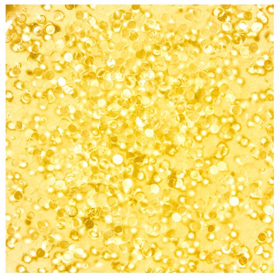 Close-up van gouden microbolletjes in de Nuxe Super Serum.