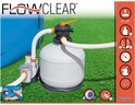 Flowclear zandfilterpomp bij een blauw zwembad op gras. Met 'Bestway' logo en icoontjes.