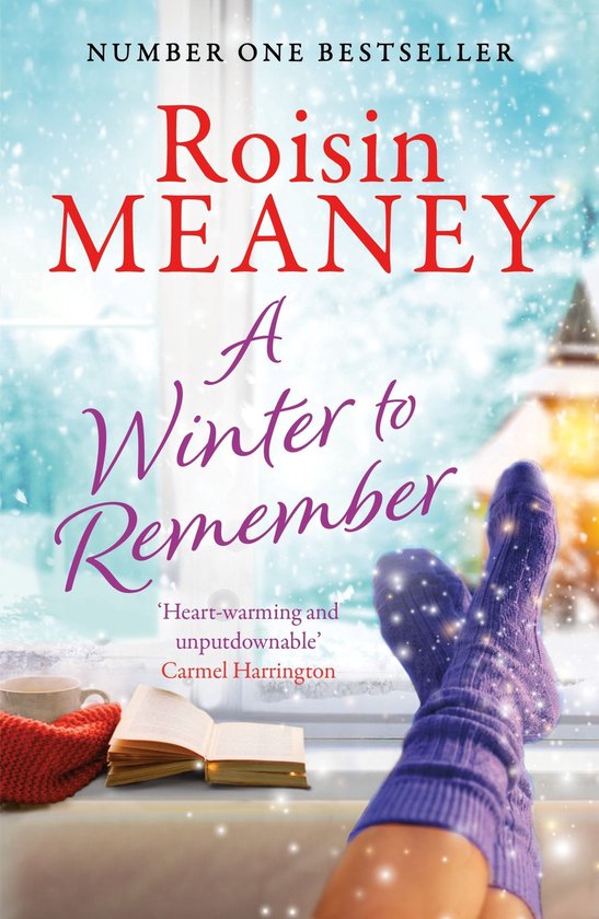 Boek 'A Winter to Remember' van Roisin Meaney, met op de voorkant een persoon met paarse, gebreide sokken, een boek en een mok bij een raam met sneeuw.