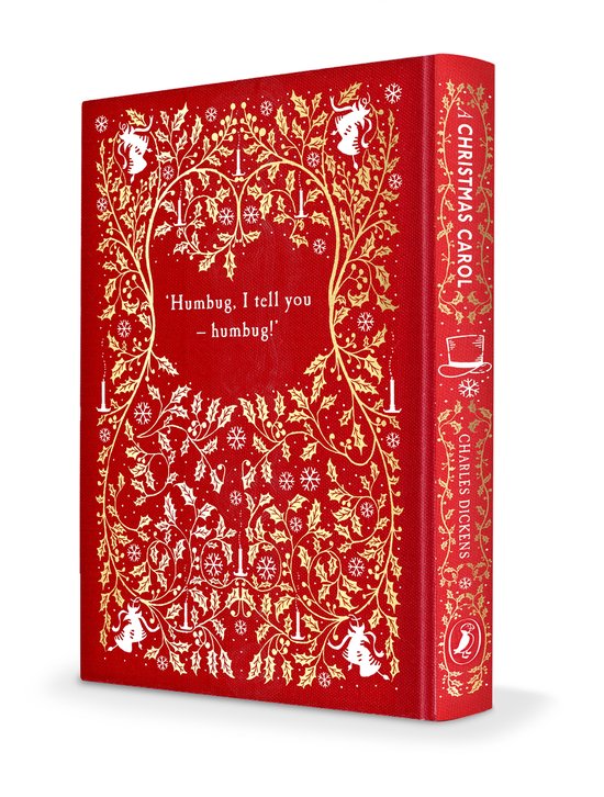 Rood boek met gouden kerstdecoraties, 'A Christmas Carol' en Charles Dickens op de rug.