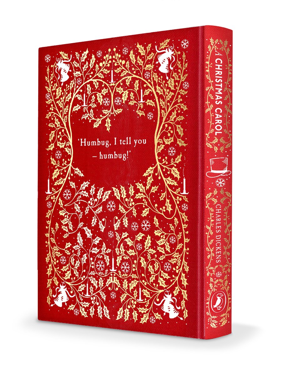 Rood boek met gouden kerstdecoraties, 'A Christmas Carol' en Charles Dickens op de rug.