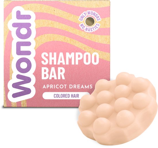 Pain de shampooing Wondr 'Apricot Dreams' pour cheveux colorés, emballage rose à motif ondulé, savon doux couleur abricot avec des picots.