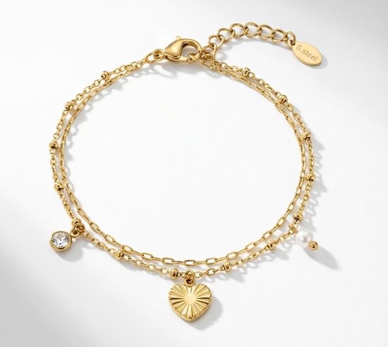 Gouden dubbel laags armband met een hartje hanger, een parel en een steentje, met 'S.steel' label.