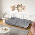 Grijze slaapbank deels uitgeklapt, in een woonkamer met wanddecoratie, witte tafels en een gestreepte stoel.