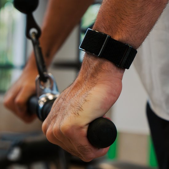 Persoon draagt een zwarte Polar Loop activity tracker tijdens het trainen.