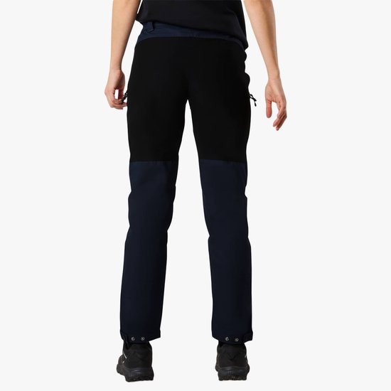 Dames outdoorbroek in het donkerblauw met zwarte panelen op de dijen en achterkant, met ritssluitingen en drukknopen.