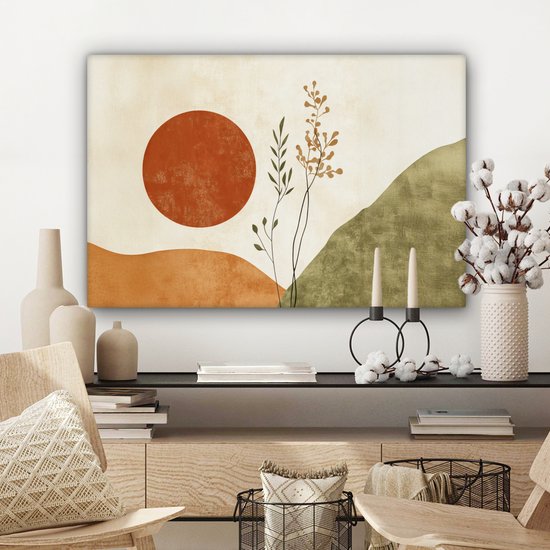 Abstract schilderij met oranje zon, takken en groene heuvels, hangend boven een dressoir.
