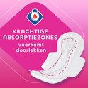 Wit maandverband met roze stiksel en de tekst 'krachtige absorptiezones voorkomt doorlekken'.