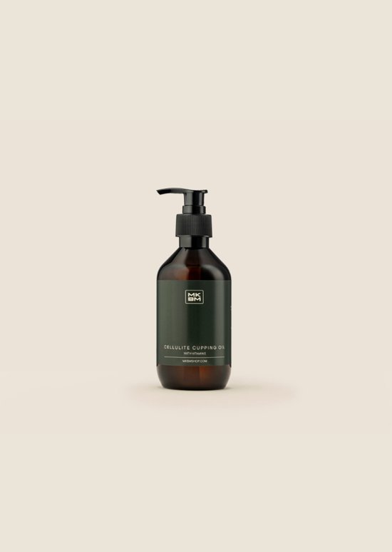 Bruine fles met pompdispenser en groen etiket met 'MKBM CELLULITE CUPPING OIL WITH VITAMIN E'.