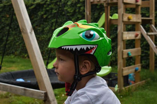 Groene kinderfietshelm met dino-design, grote ogen en scherpe tanden.