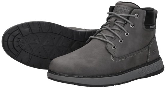 Paar donkergrijze veterschoenen, één met de zool omhoog, veters, 'WATERPROOF'-opschrift.