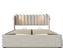 Beige gestoffeerd eenpersoonsbed met capitonné hoofdbord, voorzien van twee lampjes, zonder matras.