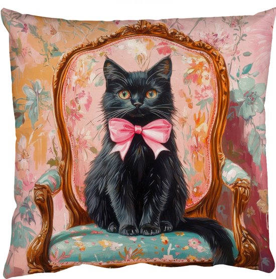 Chat noir avec nœud rose sur une chaise à motif floral, isolé.