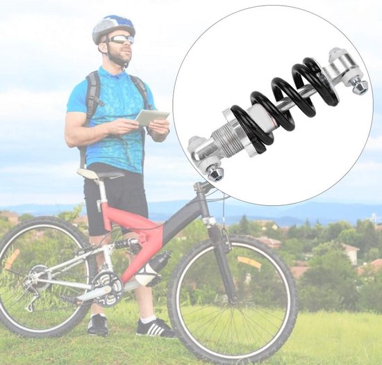Zilverkleurige fiets schokdemper met zwarte veer, in een cirkel voorgesteld.