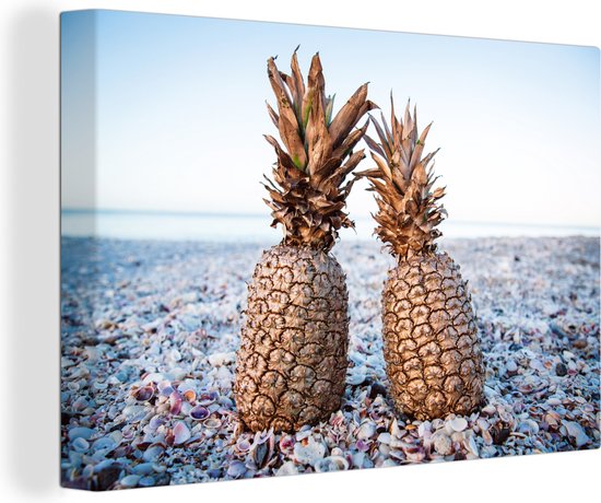 Canvas Schilderijen - Twee gouden ananassen op een schelpenstrand - Wanddecoratie