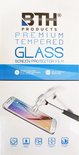 Verpakking van BTH Premium Tempered Glass screenprotector. Een smartphone wordt met een hamer bewerkt. Iconen onderaan tonen "Plane Quik", "Chokeless Resistance", "Free Touch", "Permanent Adhesives", "Scratch Proof Coating".