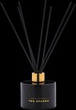 Zwarte glazen diffuser van Ted Sparks met gouden dop en 8 zwarte geurstokjes.