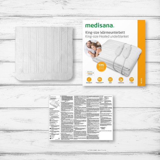 Verpakking MEDISANA kingsize warmte-onderdeken met afbeelding van een koppel en specificaties.