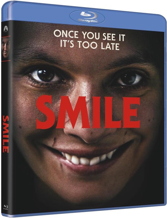 Blu-ray hoes van de film "Smile", met close-up van een angstig gezicht met een brede grijns en de tekst "SMILE".