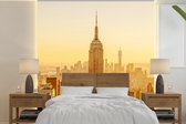 Behang - Fotobehang Gouden zonsondergang bij het Empire State Building in New York - Breedte 280 cm x hoogte 280 cm