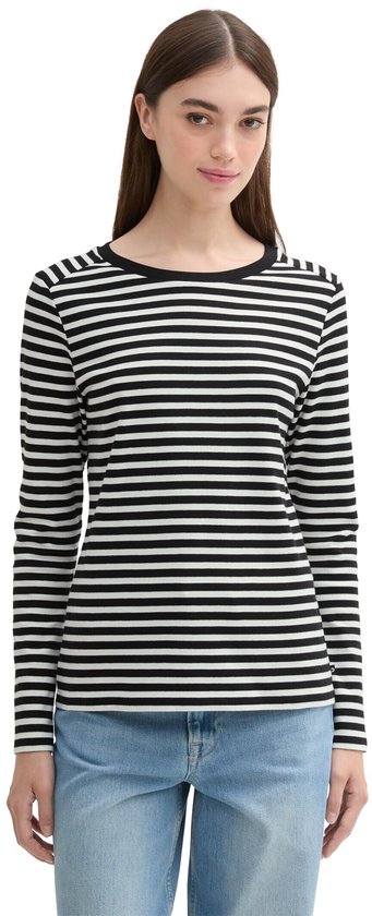 Model draagt zwart-wit gestreept T-shirt met lange mouwen en een zwarte boothals.