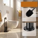 Zwarte toiletrolhouder met toiletborstel naast een toilet.