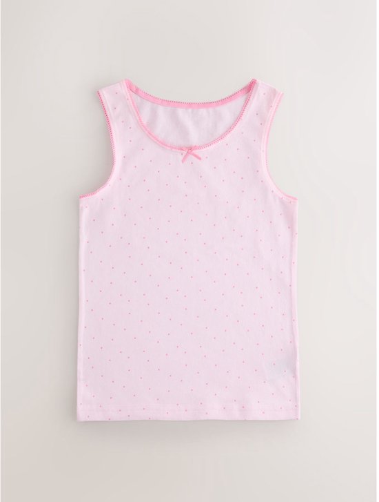 Roze hemdje met all-over roze stippenprint en roze strikje en festonrand.