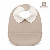Beige baby slabbetje met een witte, ronde kraag en een praktische opvangbak aan de onderkant.