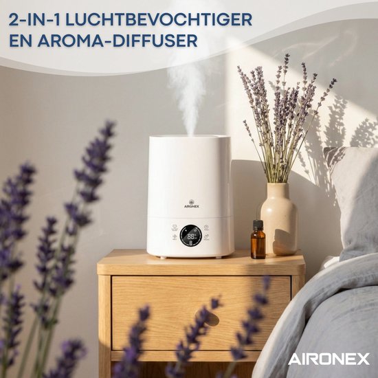 Witte Aironex luchtbevochtiger met digitale display, met lavendel takken en flesje geurolie ernaast.