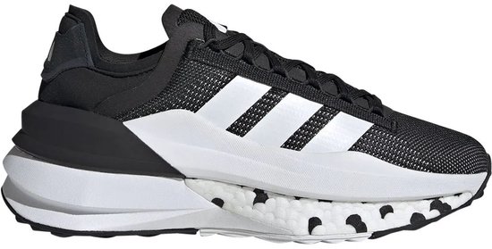 Vue latérale d'une chaussure de sport noire avec bandes Adidas blanches et semelle blanche à pois noirs.
