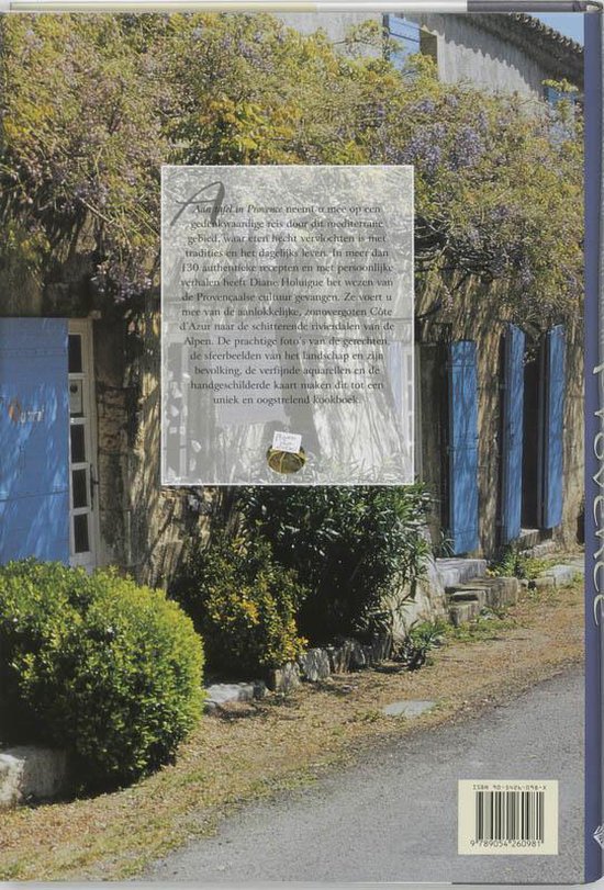 Boekomslag met tekst "Aan tafel in Provence" en een foto van een stenen huis met blauwe luiken en bloeiende planten.