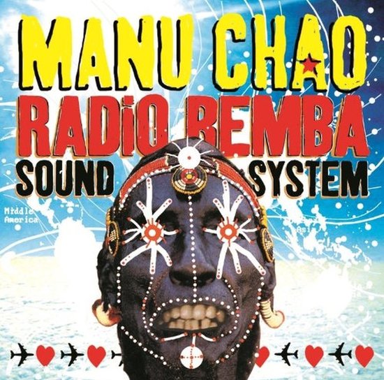 Albumcover met felgekleurde tekst 'MANU CHAO RADIO REMBA SOUND SYSTEM' en een zwart gezicht met witte, rode en blauwe versieringen. Vliegtuigen en harten onderaan.