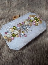 Details: Handmade resin clutch in a hexagonal shape embellished with gems and finished with a flower clasp. Comes with a golden sling. One chamber. No inner pocket. No side pocket. color white