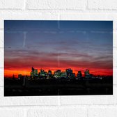 Muursticker - Zonsondergang achter Gebouwen met Verlichting - 40x30 cm Foto op Muursticker