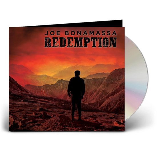 Cd-hoesje met cd, waarop een man staat op een berglandschap bij zonsondergang. Titel 'REDEMPTION'.