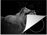 KitchenYeah® Inductie beschermer 77x59 cm - Twee galopperende paarden in een grasland in zwart-wit - Kookplaataccessoires - Afdekplaat voor kookplaat - Inductiebeschermer - Inductiemat - Inductieplaat mat